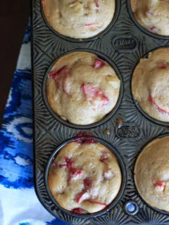 Strawberry rhubarb muffins with a dash of cinnamon, using greek yogurt instead of milk and applesauce instead of oil. This is a great way to bake with rhubarb and eat up some of your strawberries too! | trialandeater.com