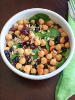 Spinach Chickpea Salad - a bowl of deliciousness! Protein, veggies, fruit, seeds, and nuts = flavor that will make you say goodbye to your normal boring salad.