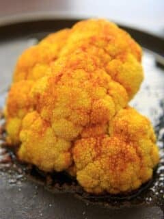 Turmeric Roasted Cauliflower Halves - a unique way to bake cauliflower and a colorful + flavorful side.