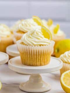 lemon cupcake with lemon buttercream frosting on a white mini cupcake stand