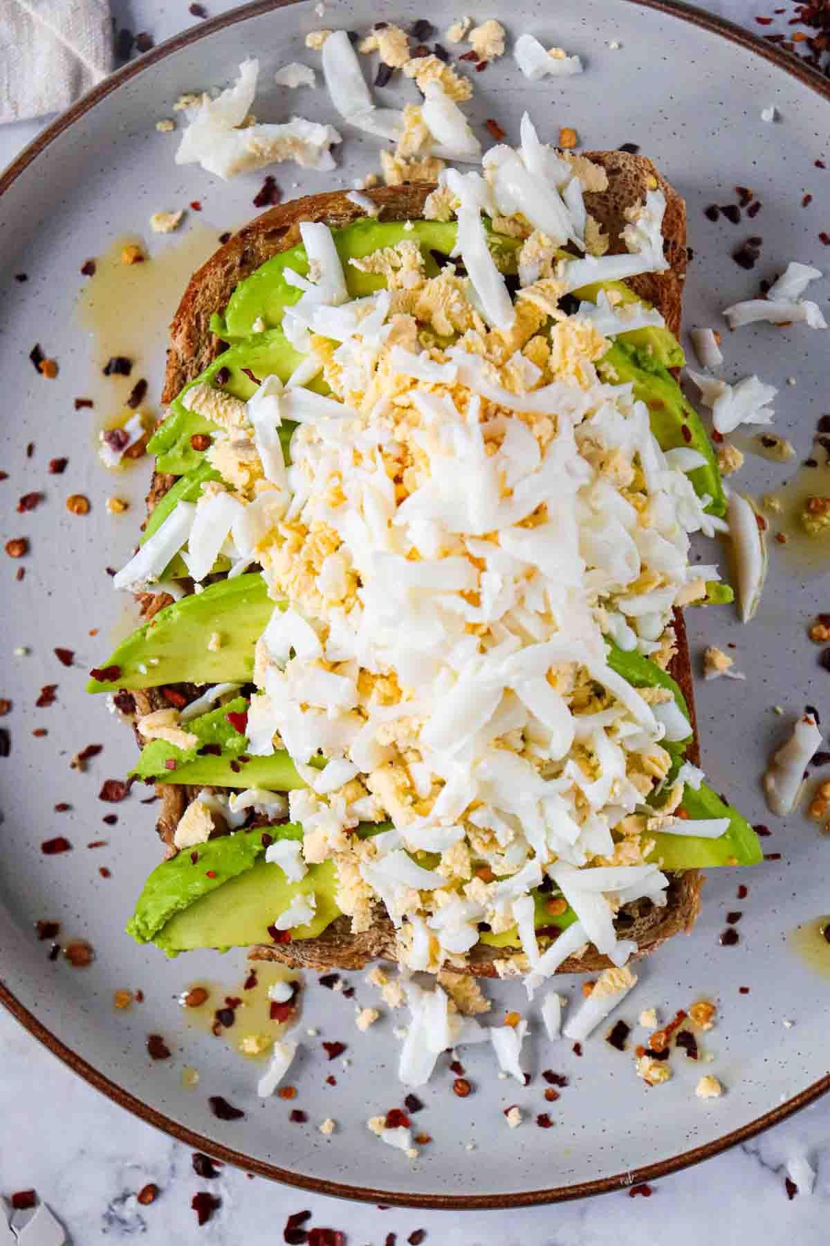 grated hard boiled egg on top of avocado toast