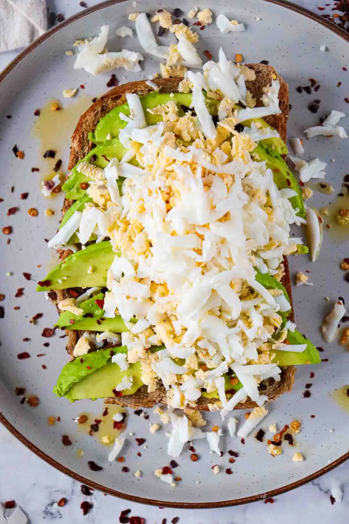 grated hard boiled egg on top of avocado toast