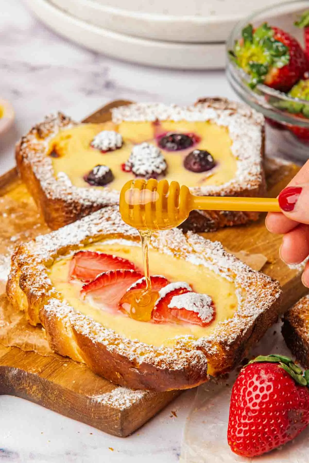 drizzling honey over custard filled toast