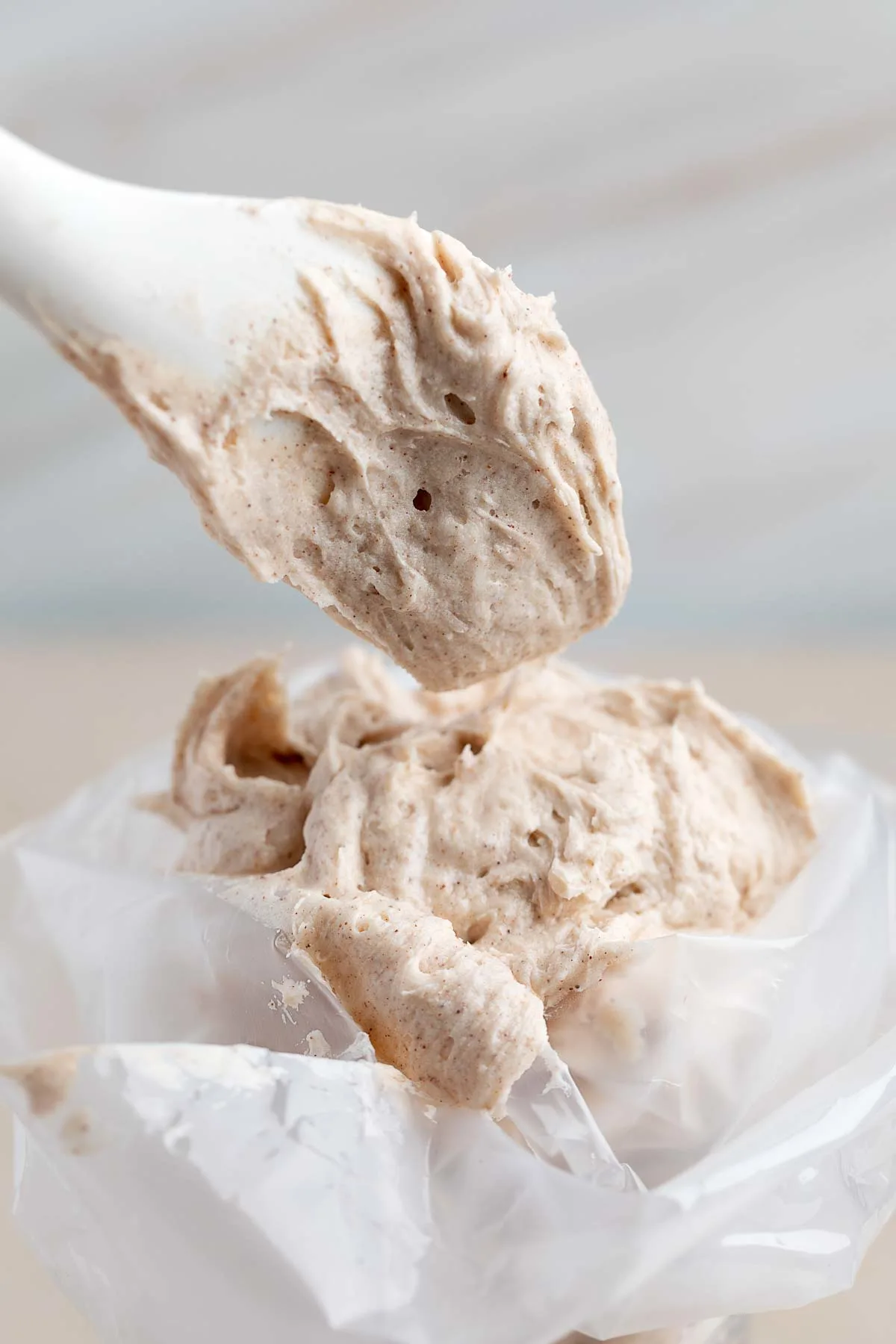 closeup of cinnamon cream cheese frosting in a bag