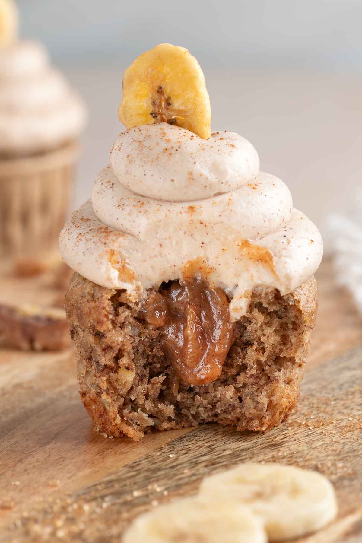 banana bread cupcake cut in half so you can see the banana jam filling coming out