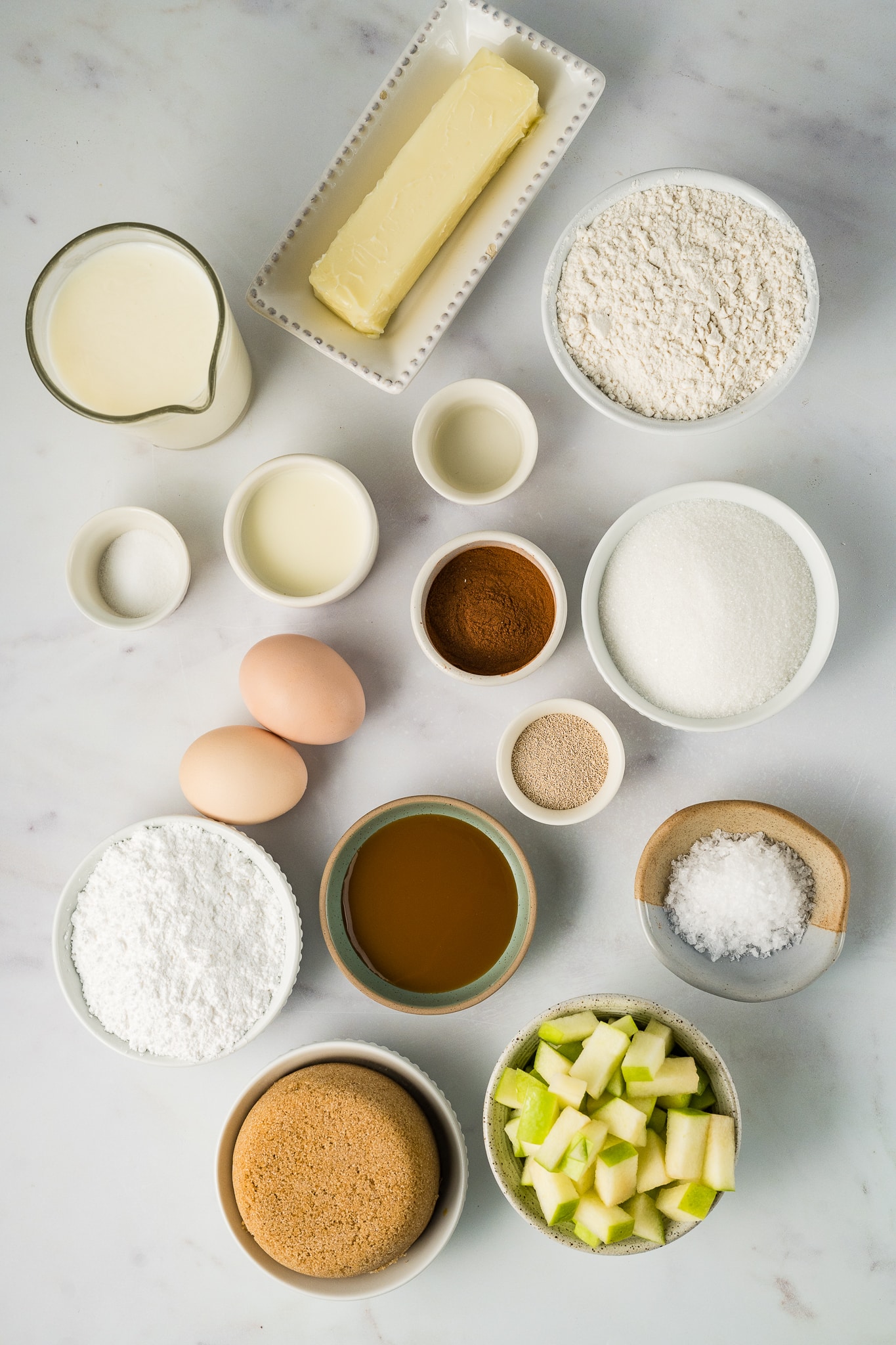 ingredients for caramel apple cinnamon rolls in individual bowls