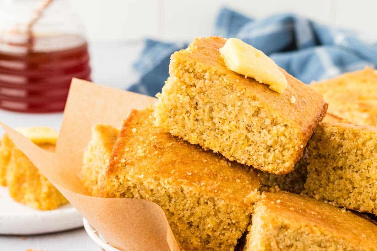 basket of gluten free cornbread with a dollop of butter