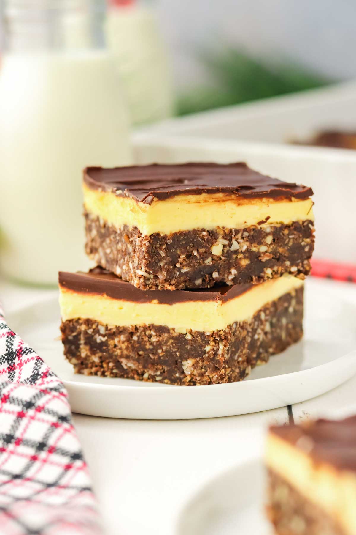 2 Nanaimo Bars stacked on white plate