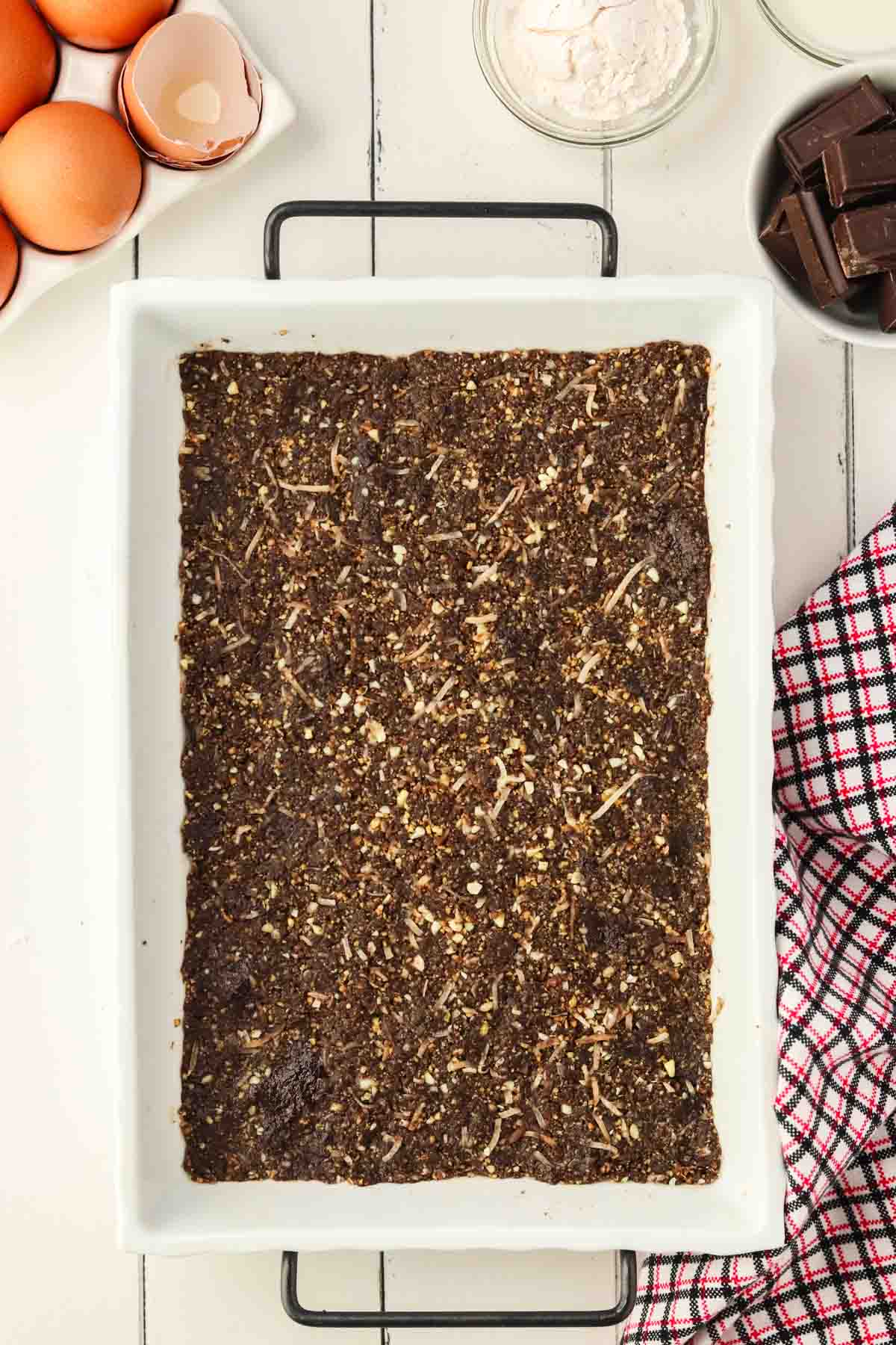 chocolate graham cracker layer in white casserole dish