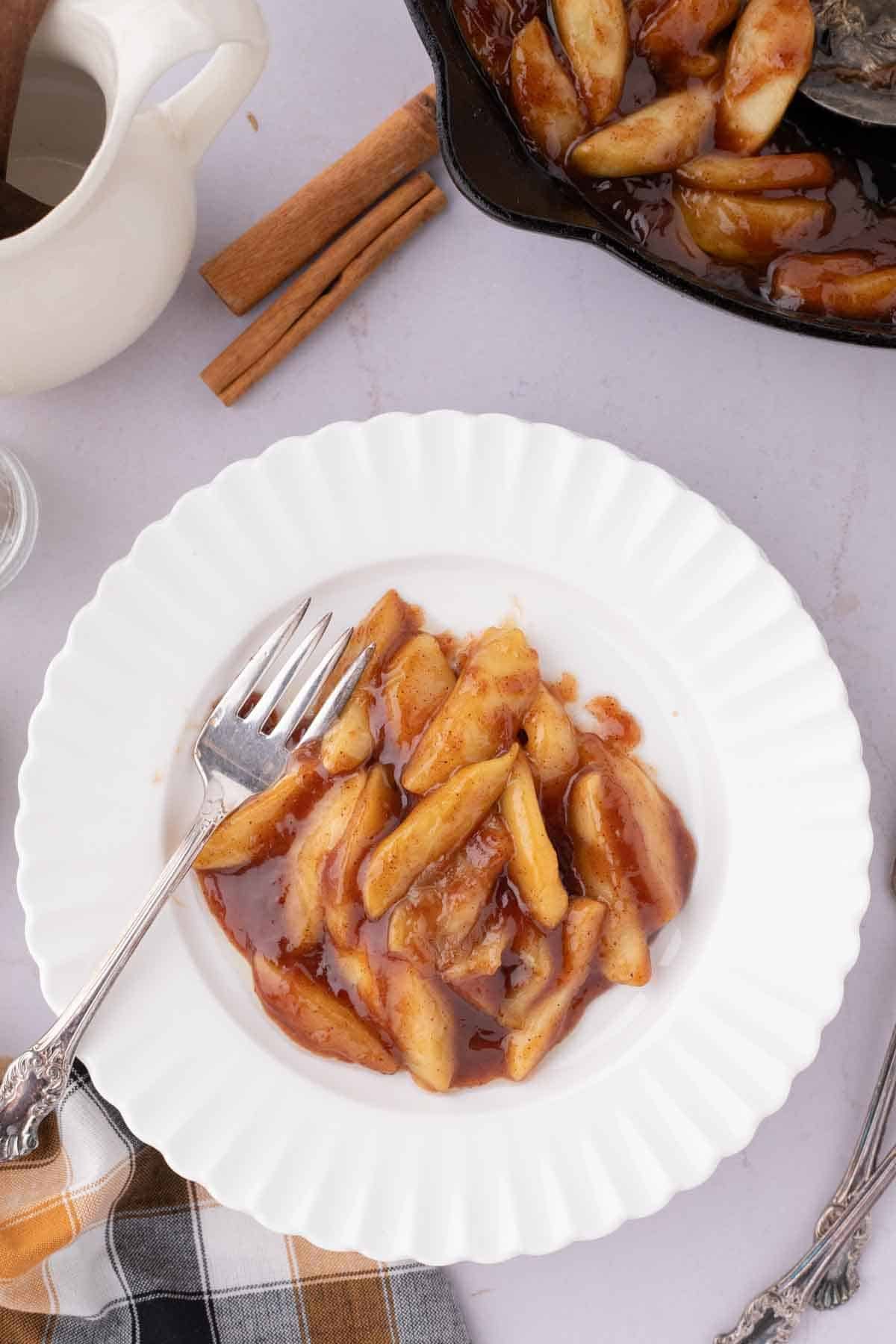 southern fried apples on a white plate with fork