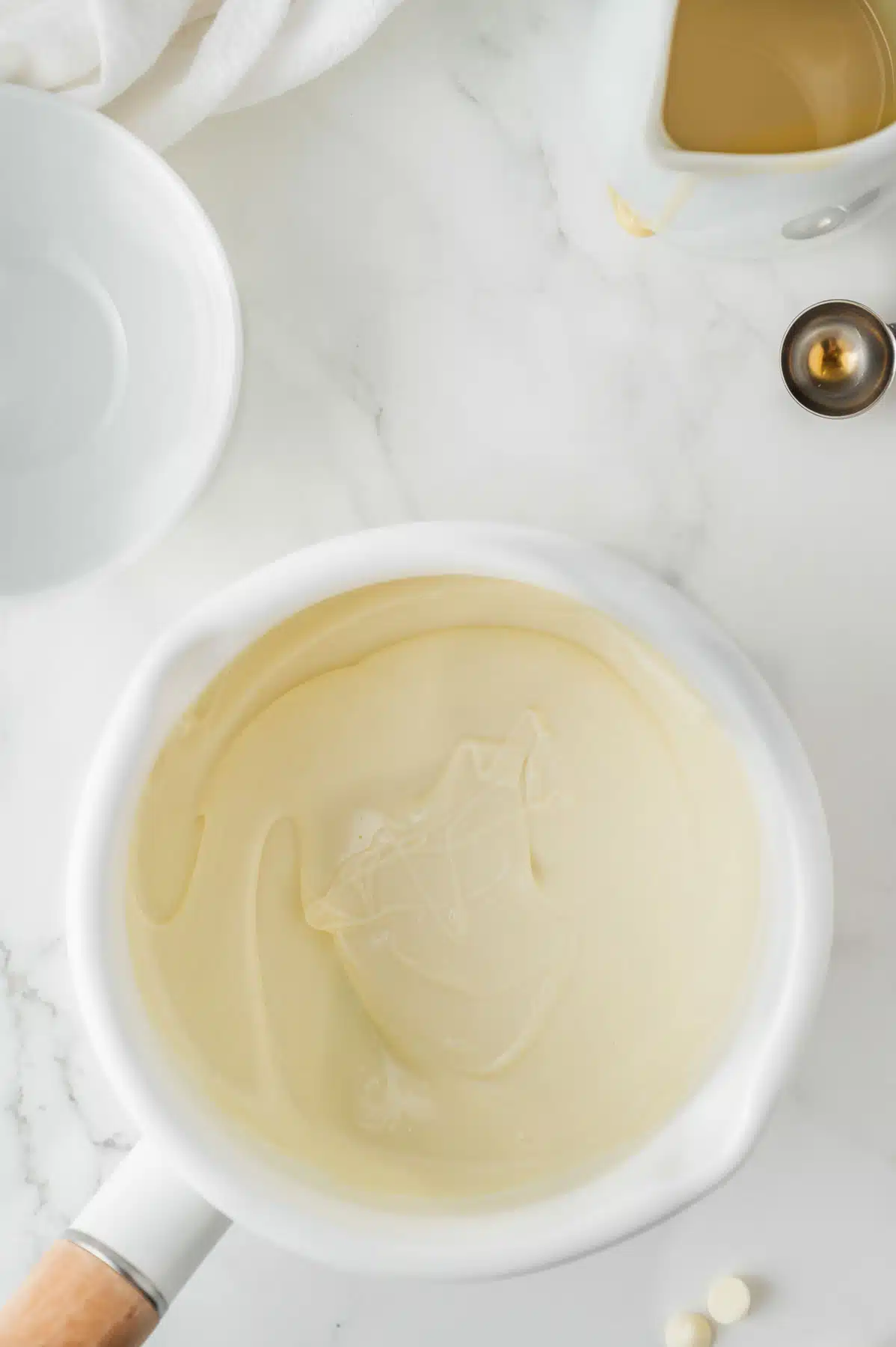 melted white chocolate chips in a white bowl