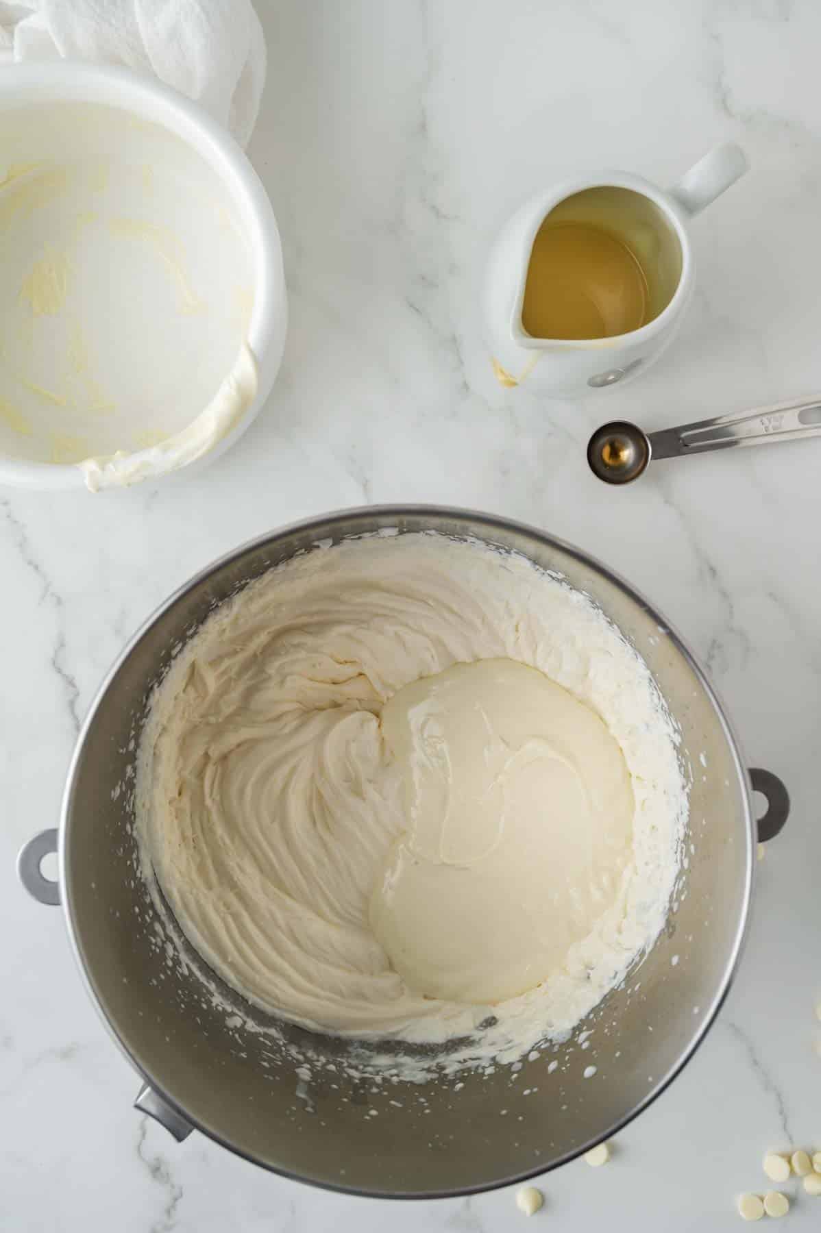 adding melted white chocolate chips to the sweetened condensed milk mixture for ice cream