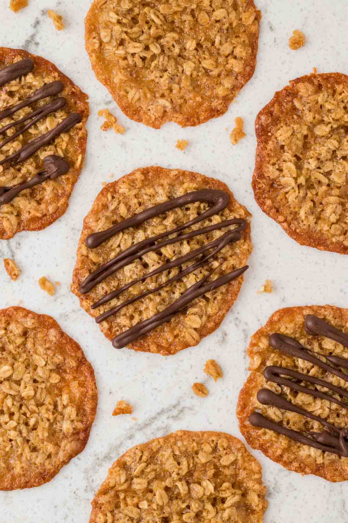 7 cookies partially in picture, 3 with chocolate drizzle, on counter