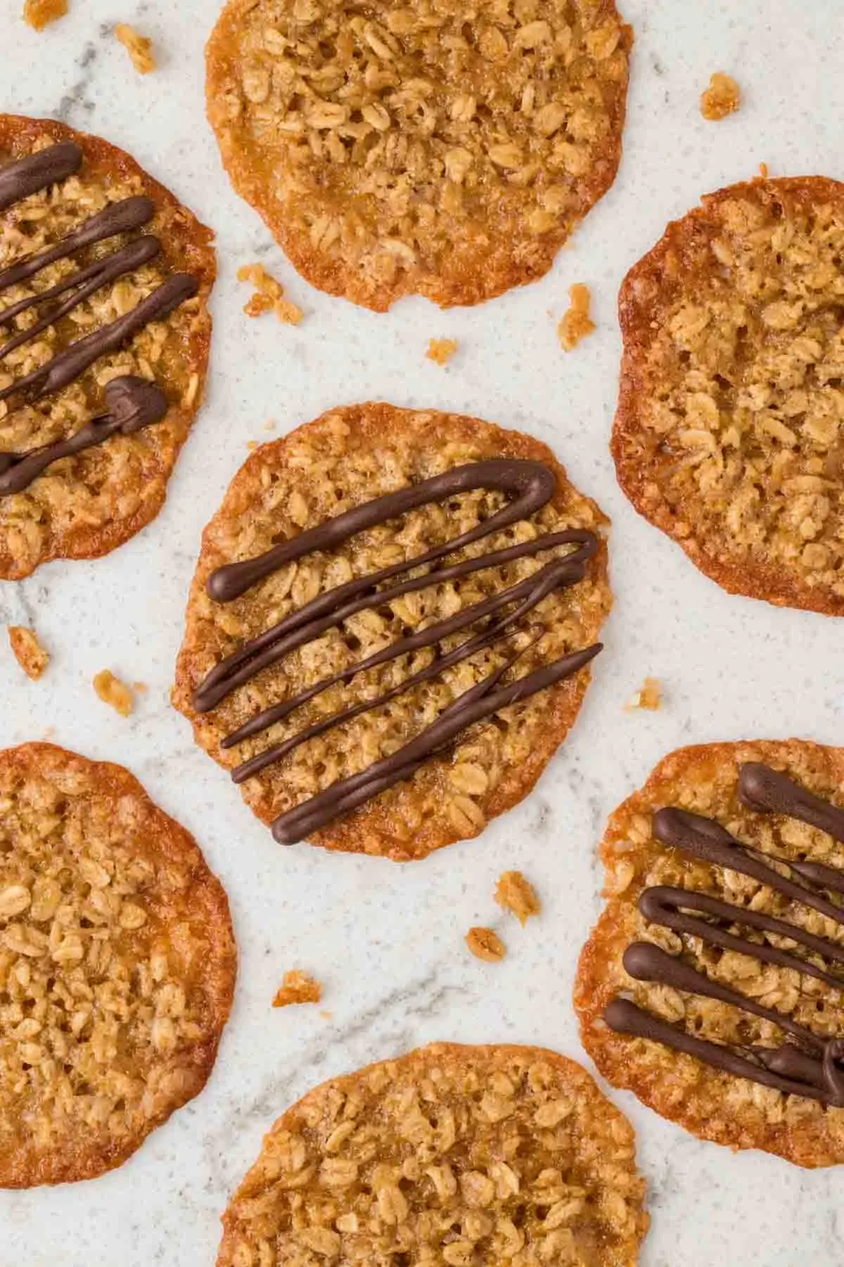 7 cookies partially in picture, 3 with chocolate drizzle, on counter