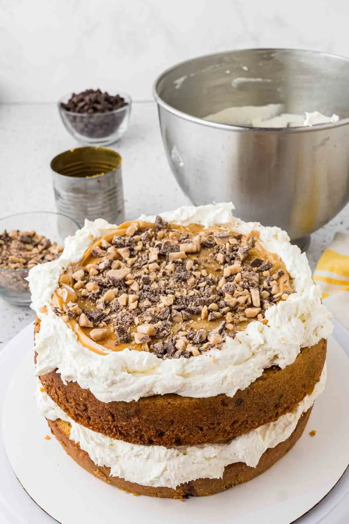 2 layers of banana cake stacked, each with buttercream around the sides and filled with toffee and caramel