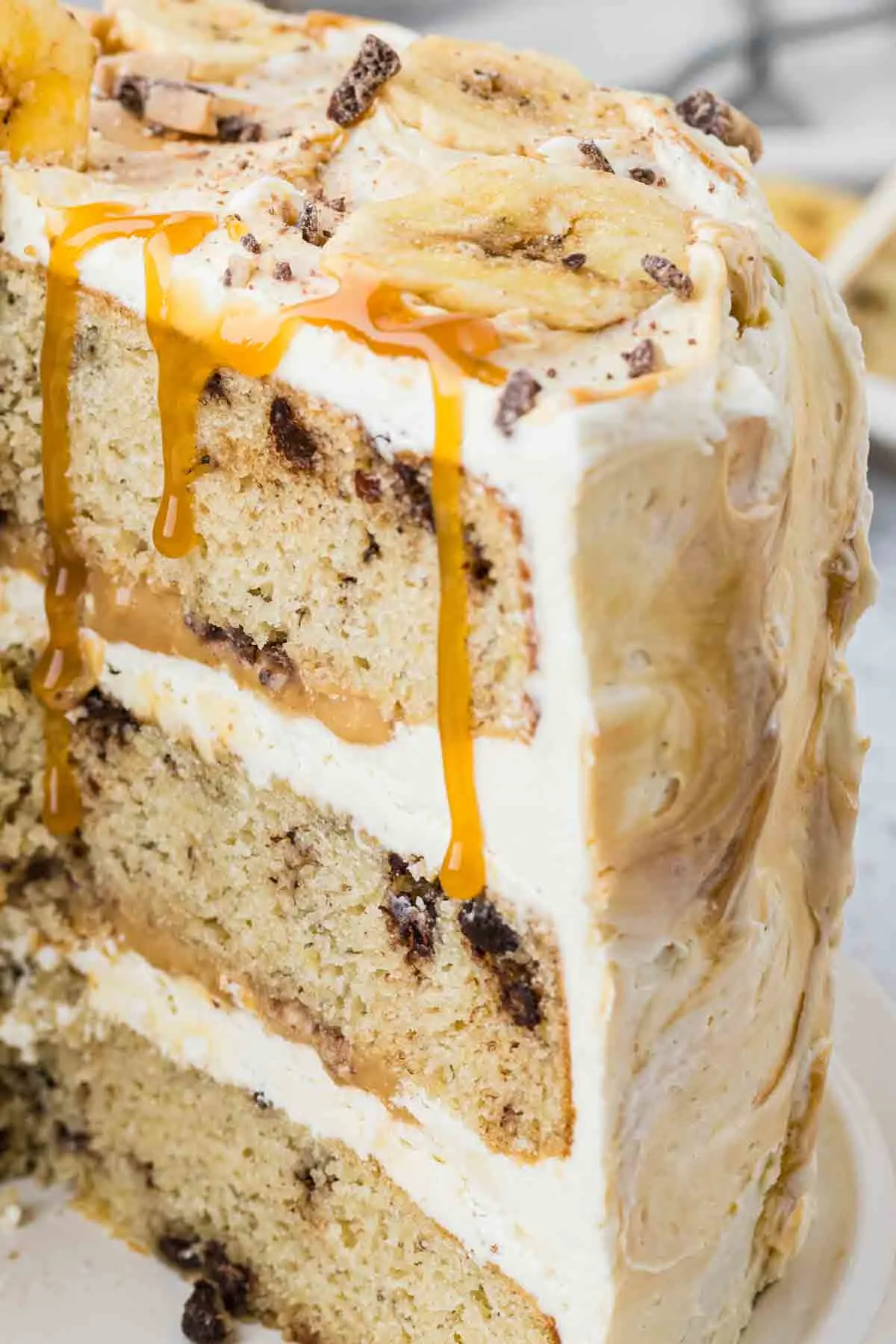 closeup of the inside of the layers of banoffee cake with caramel drizzling down