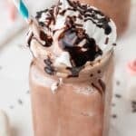 frozen hot cocoa in a mason jar with a blue and white straw