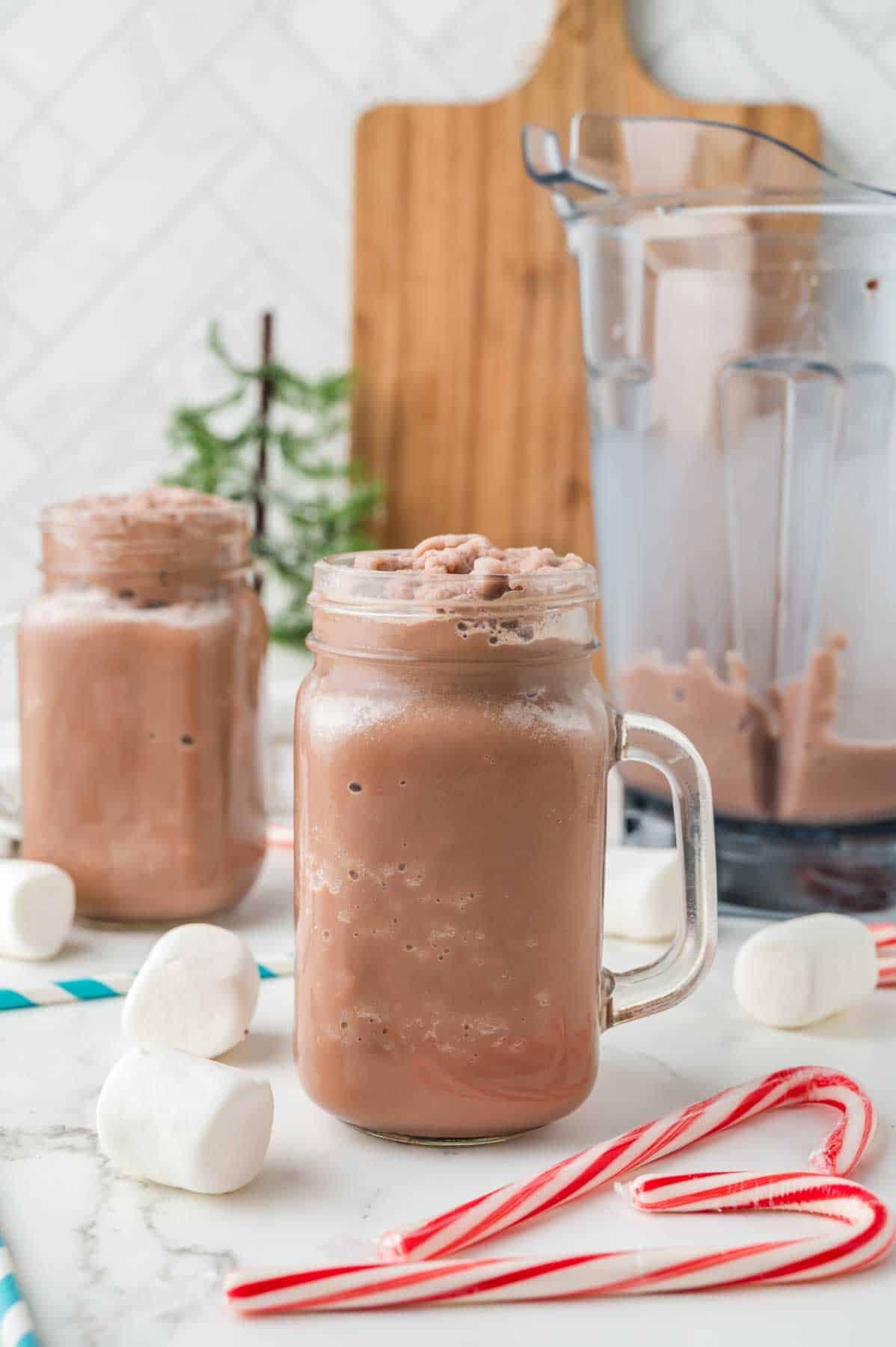 two frozen hot cocoas in mason jars with no toppings