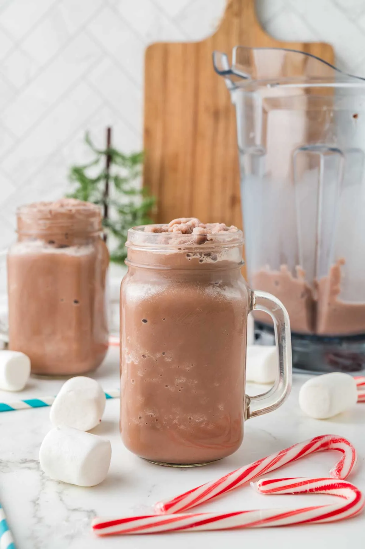 two frozen hot cocoas in mason jars with no toppings