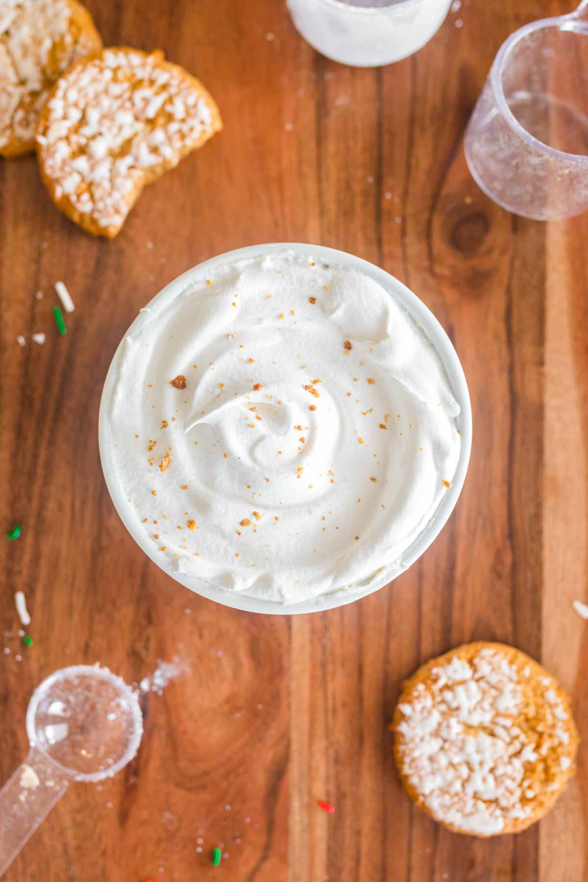 iced oatmeal cookie dip recipe with cookies next to it on wooden tray