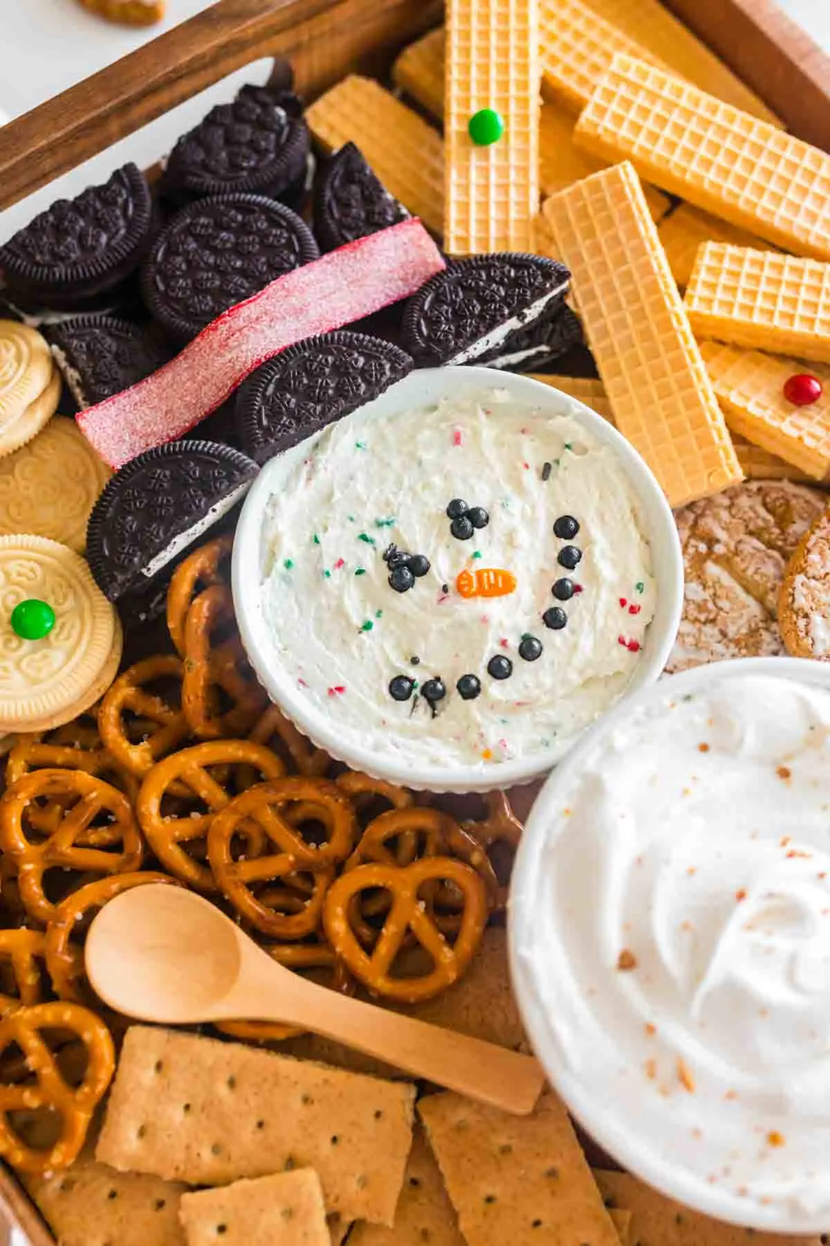 a close up of the snowman smiley face dessert dip with oreos as the hat