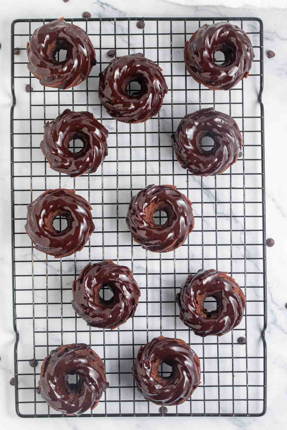 11 mini chocolate bundt cakes on a cooling rack.