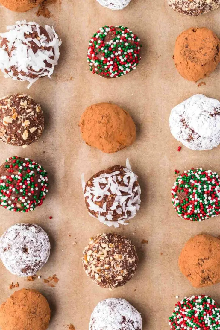 Chocolate Rum Balls with different toppings on parchment paper.