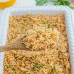 spooning out french onion rice from casserole dish