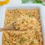 spooning out french onion rice from casserole dish