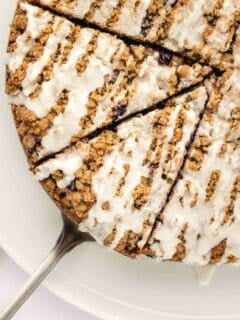 overhead view of icing covered, sliced blueberry coffee cake.